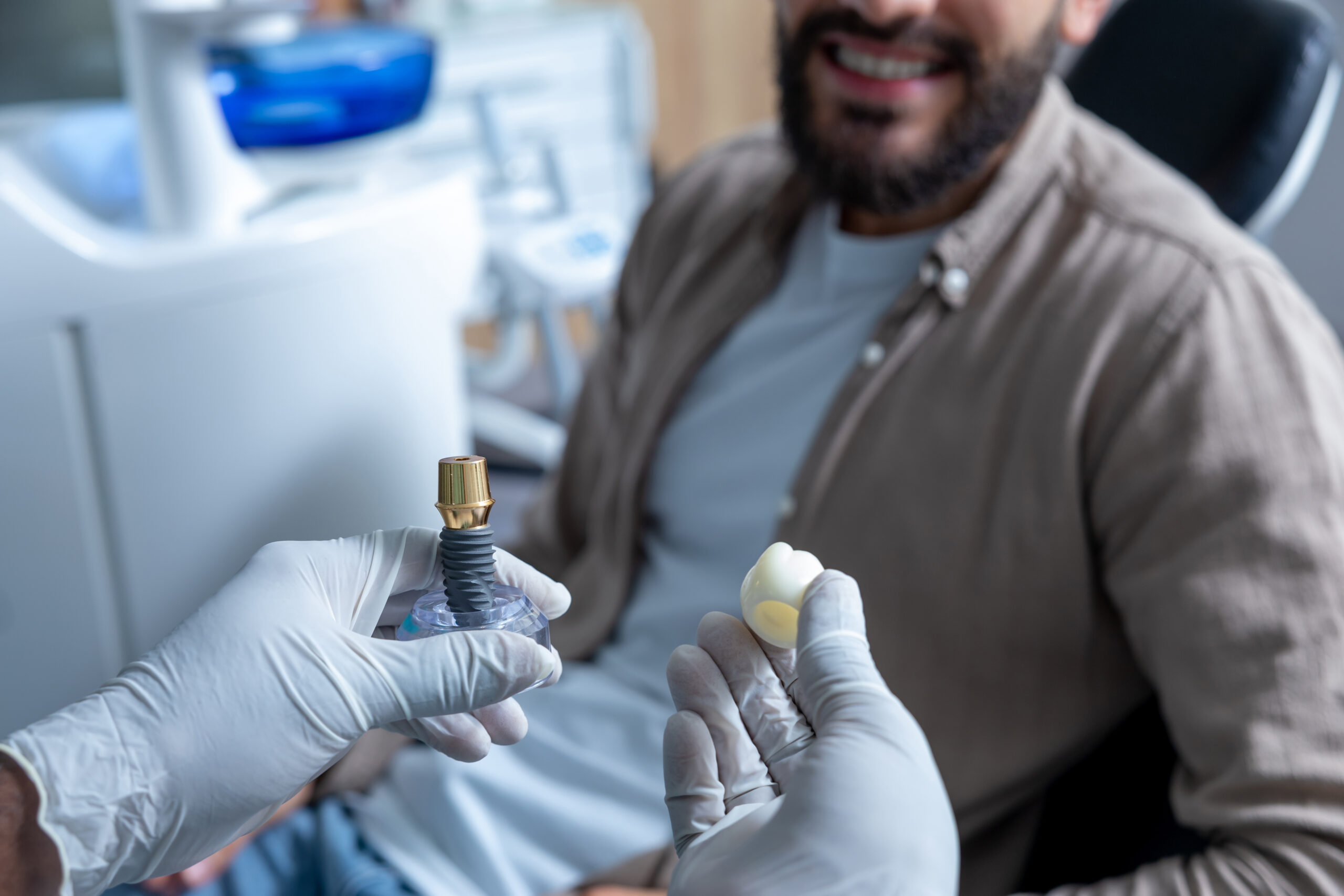 dentist-showing-tooth-model-while-explaining-dental-implant-surgery-patient-clinic-2-scaled.jpg dentist-showing-tooth-model-while-explaining-dental-implant-surgery-patient-clinic-2-scaled.jpg